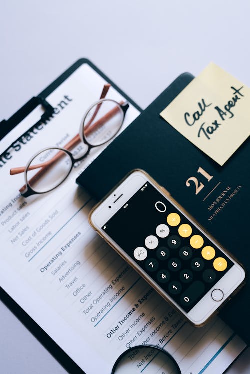 A Smartphone Calculator on a Planner With a Sticky Note