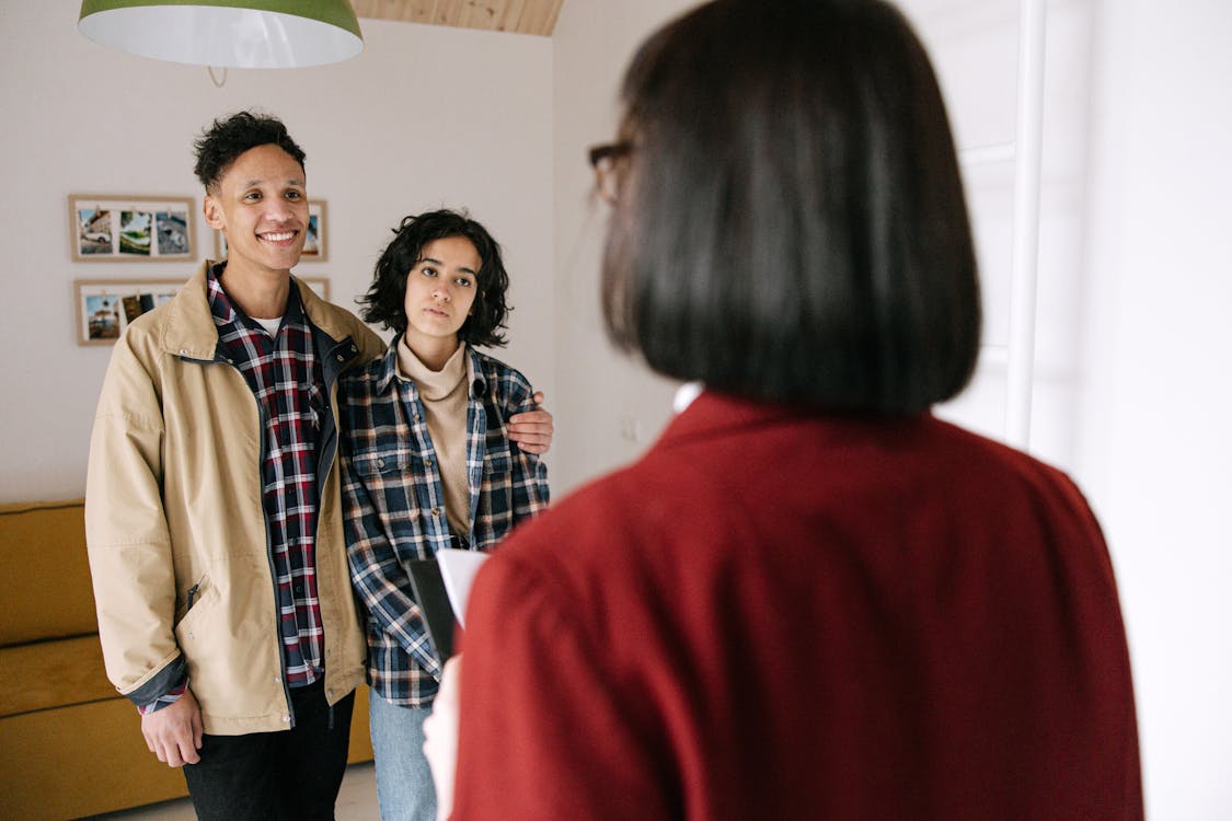 Realtor showing clients a house for sale