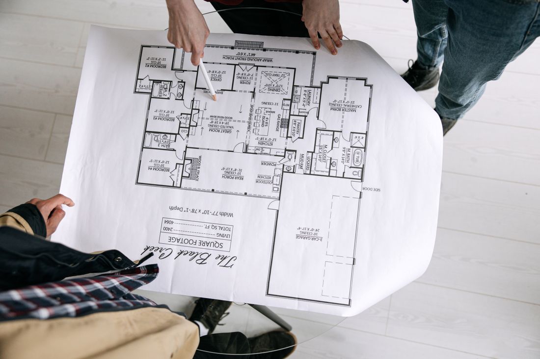 Architects examining a floor plan during BIM consulting