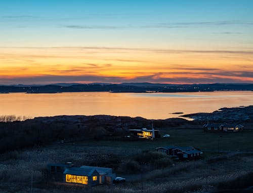 Aerial Photography of Houses near Sea during Sunset