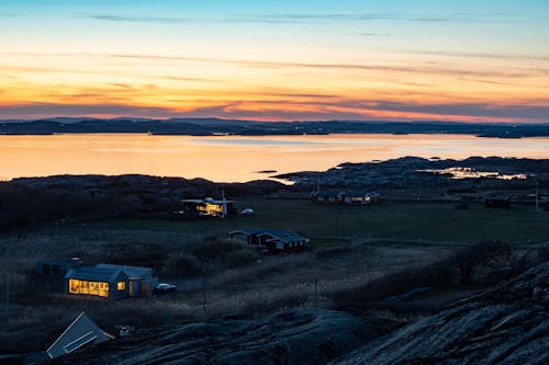 Aerial Photography of Houses near Sea during Sunset