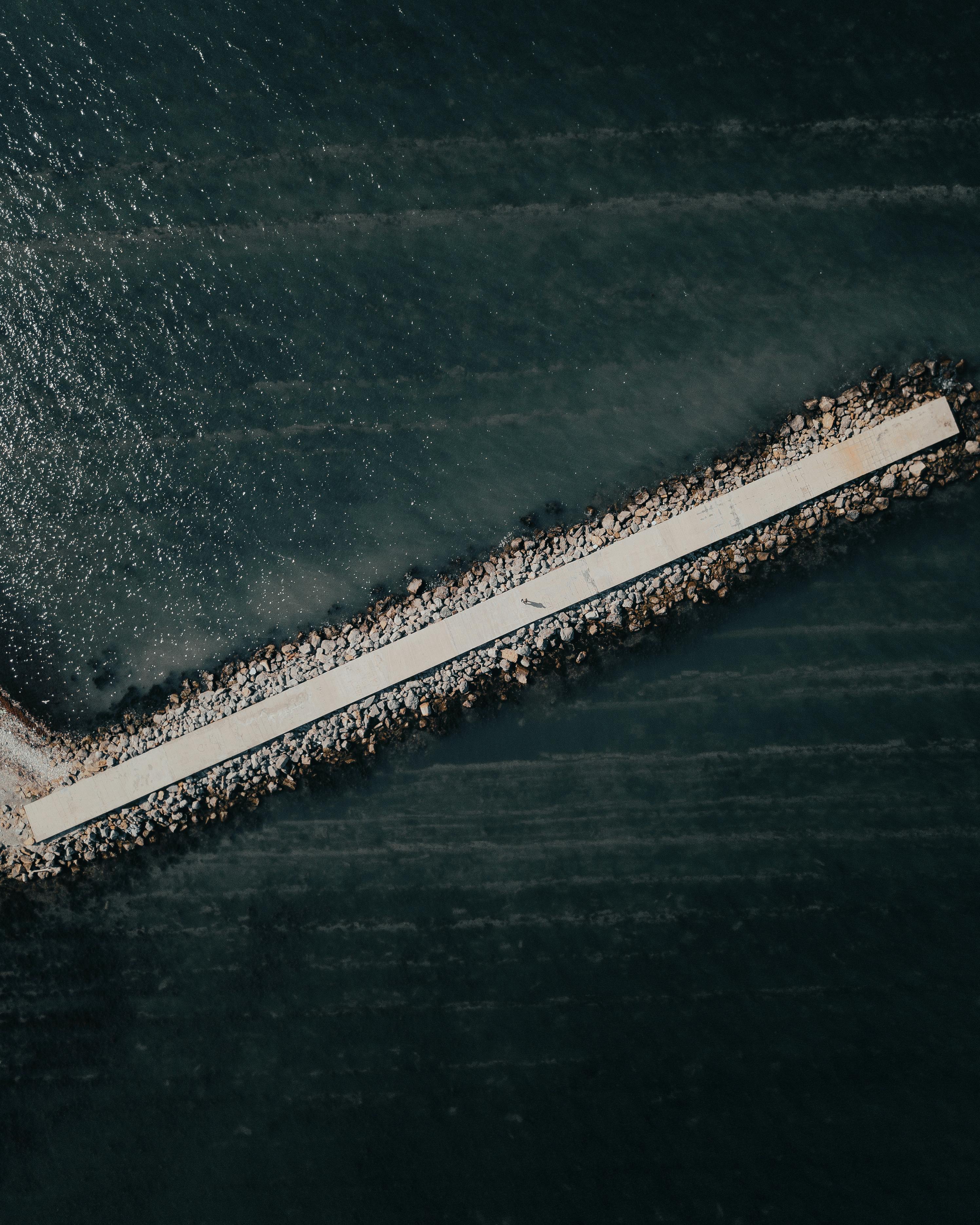 Drone shot of a long pier in Anapa, Russia extending into the sea.