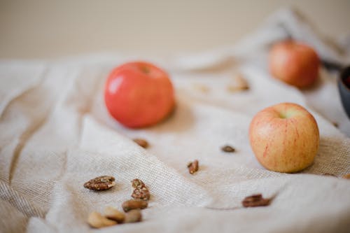 Close-up of Apples and Nuts Lying on a Cloth 