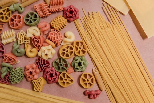 Free Top view of various colorful and textured raw pasta on a light surface. Stock Photo