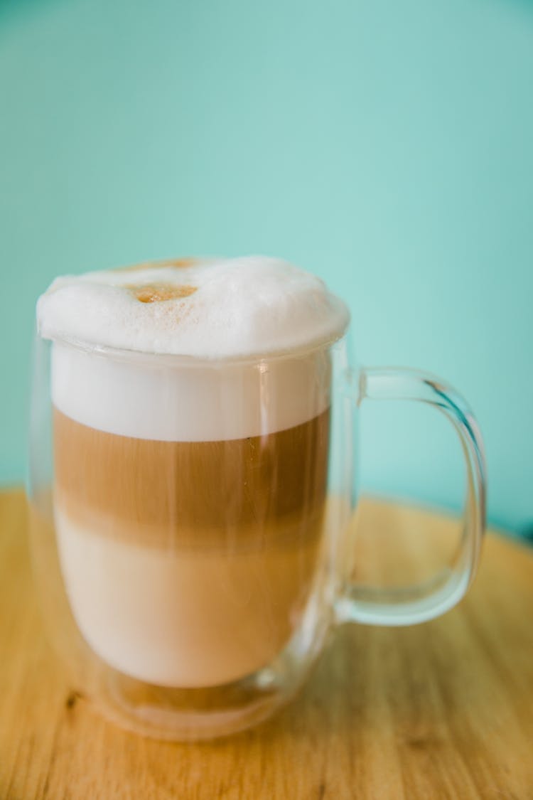 A Foamy Latte In A Glass Cup