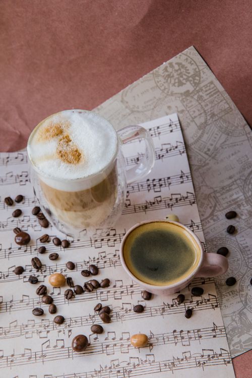 Free Explore the fusion of coffee culture with artistic musical notes in this captivating still life. Stock Photo