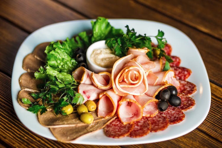 Assorted Ham On A White Ceramic Plate