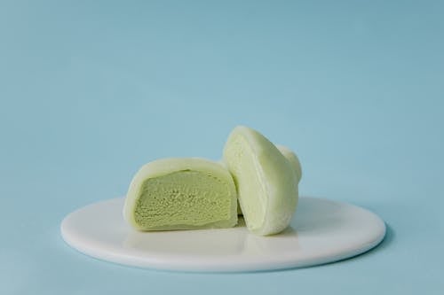 Sliced Green Mochi Ice Cream on White Ceramic Plate