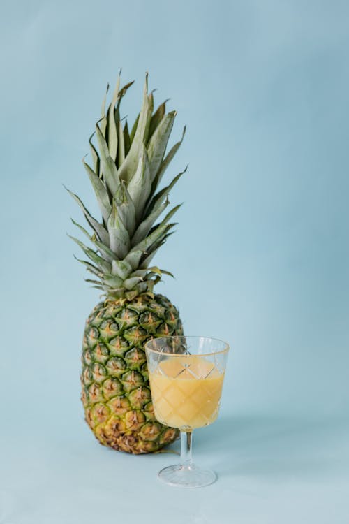 Free Pineapple Fruit and a  Glass of Juice Stock Photo