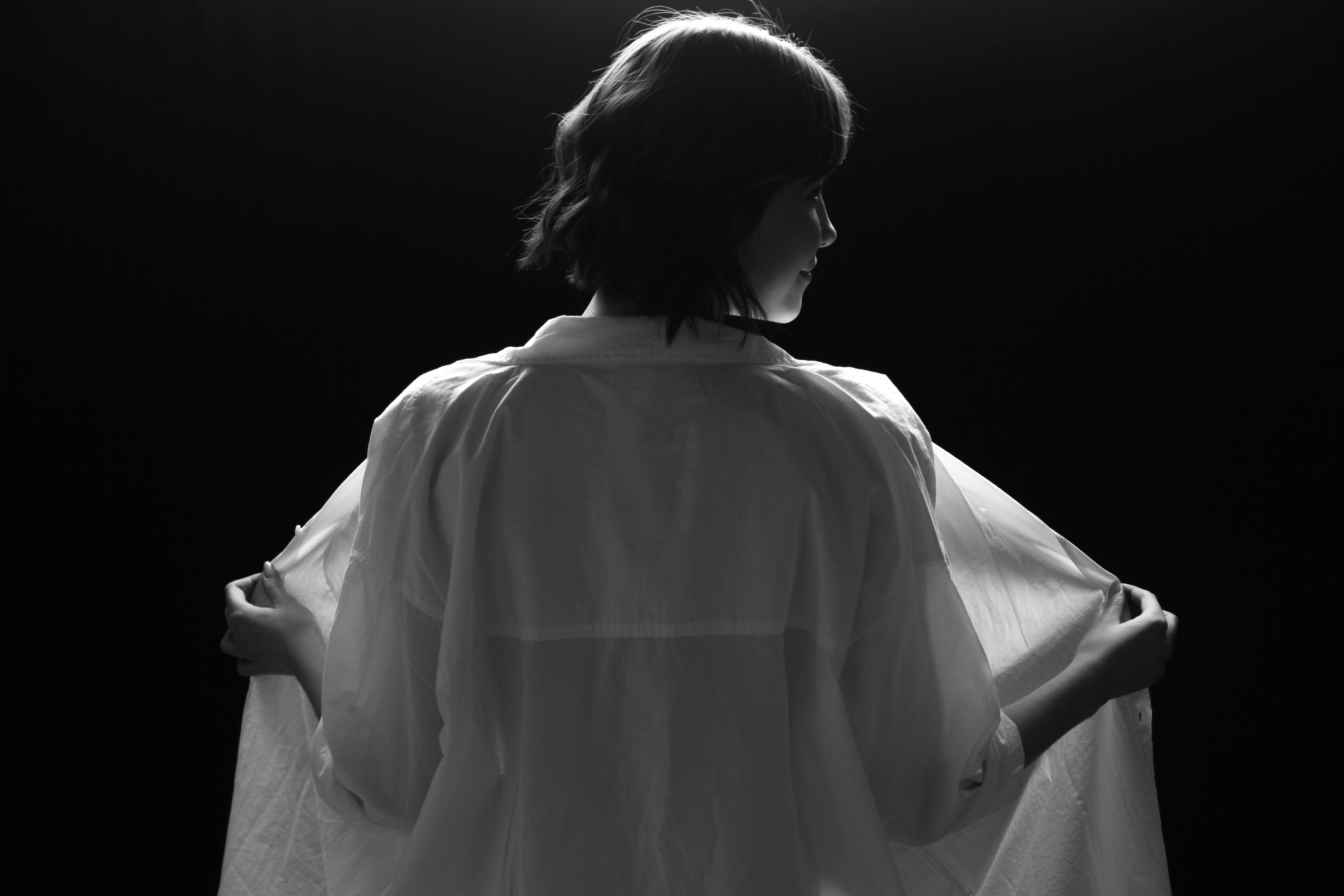 Grayscale Photo of Woman in White Long Sleeve Shirt · Free Stock Photo