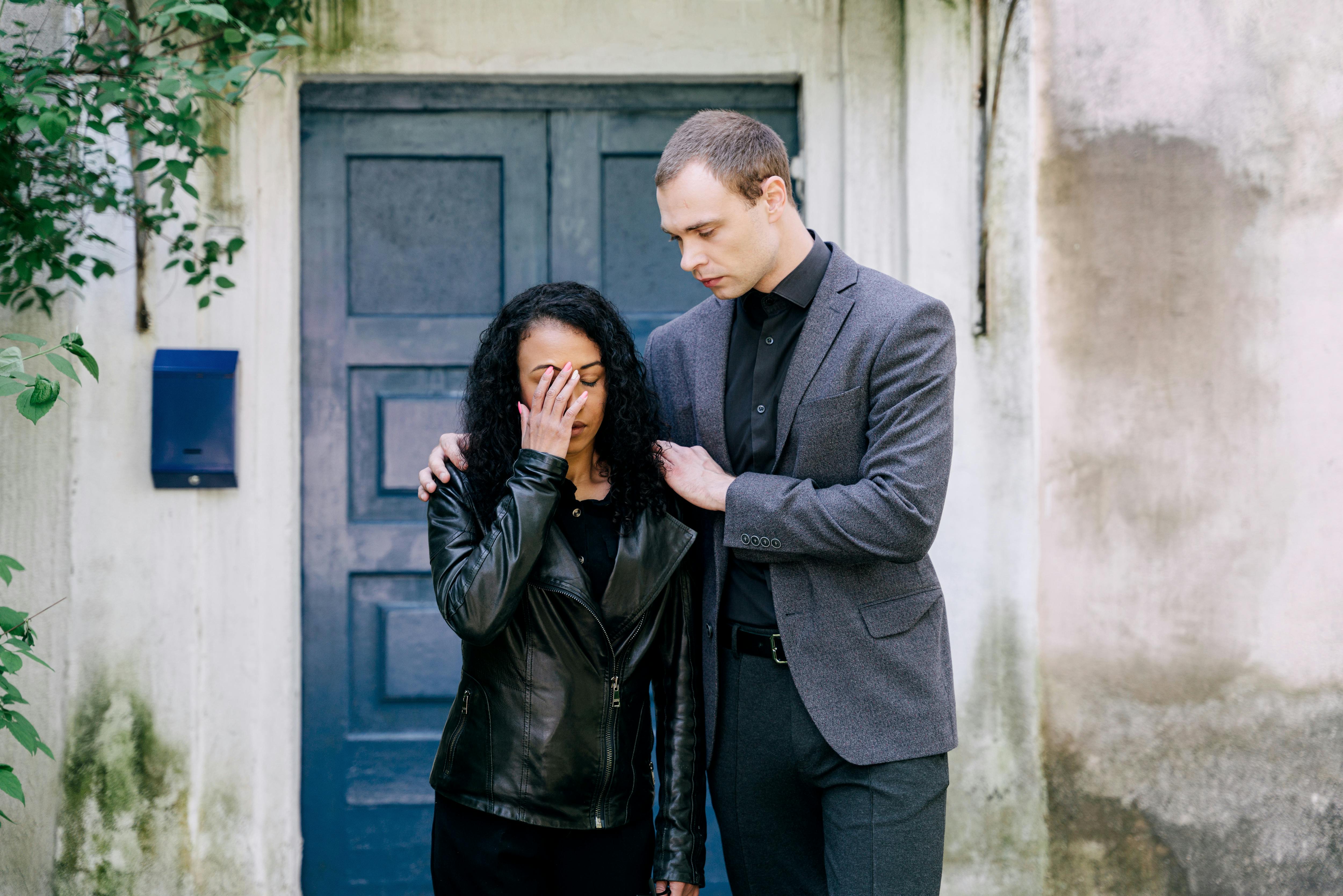 Free A Man Comforting a Woman in Black Leather Jacket Stock Photo