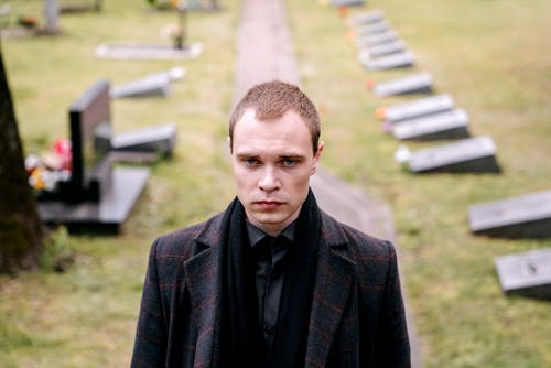 Free Man in Black Suit Jacket Walking in Cemetery Stock Photo