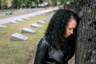 Woman Leaning Her Head on the Tree Trunk