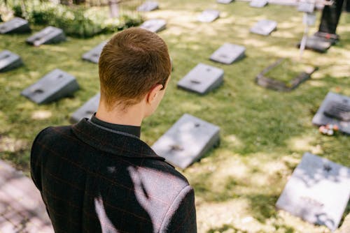 Free Man in Black Clothes Standing on Graveyard Stock Photo