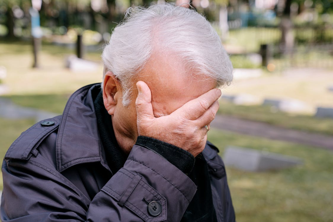 An Elderly Man Covering His Face · Free Stock Photo