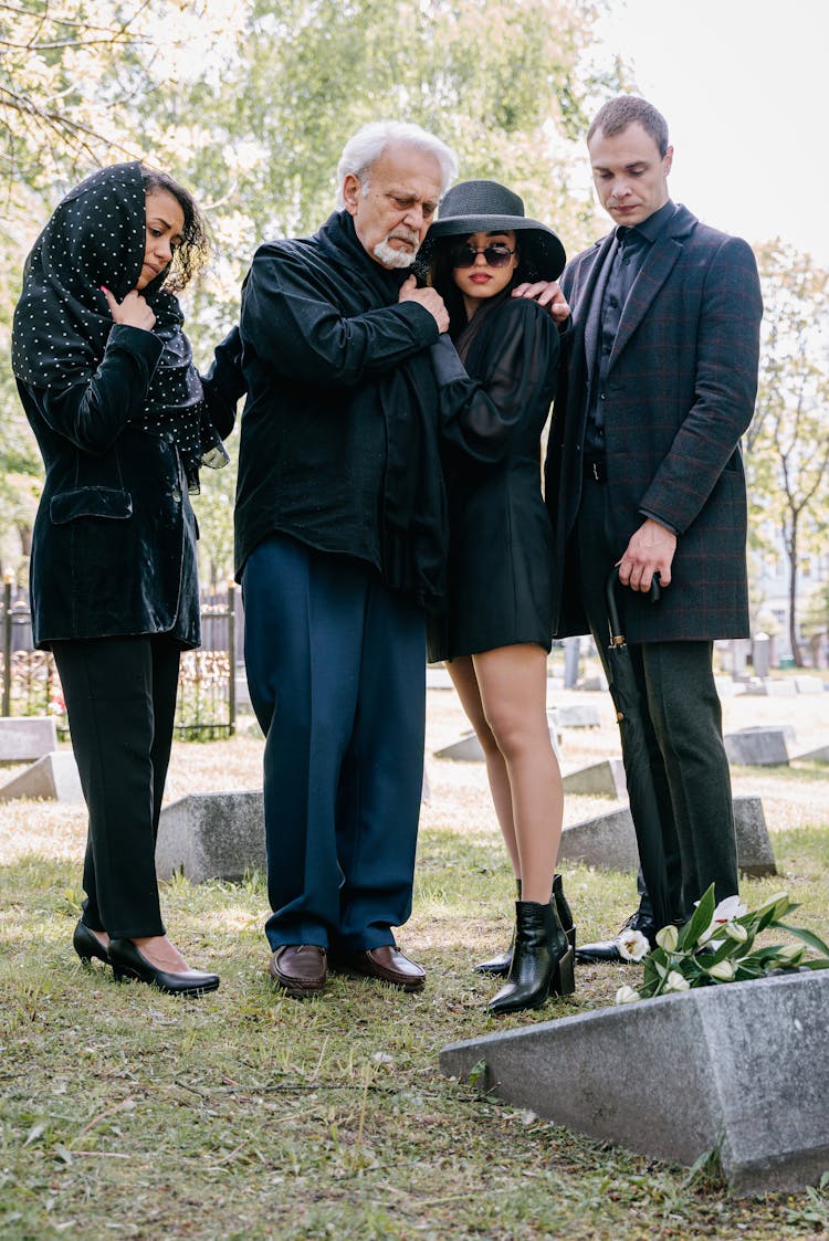 A Family Mourning In A Cemetery