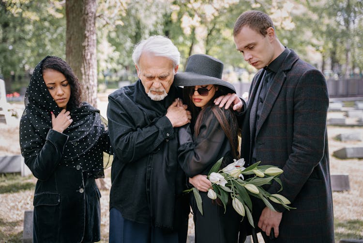 
A Family Mourning In A Cemetery