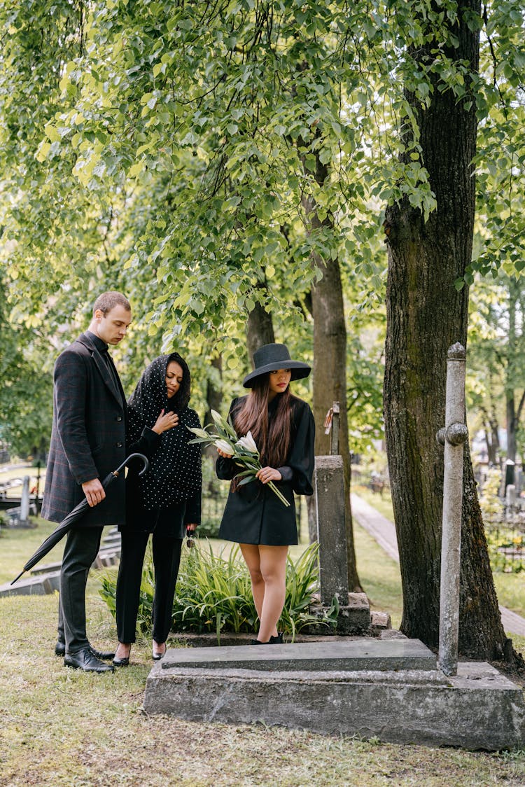 A Family Mourning In A Cemetery