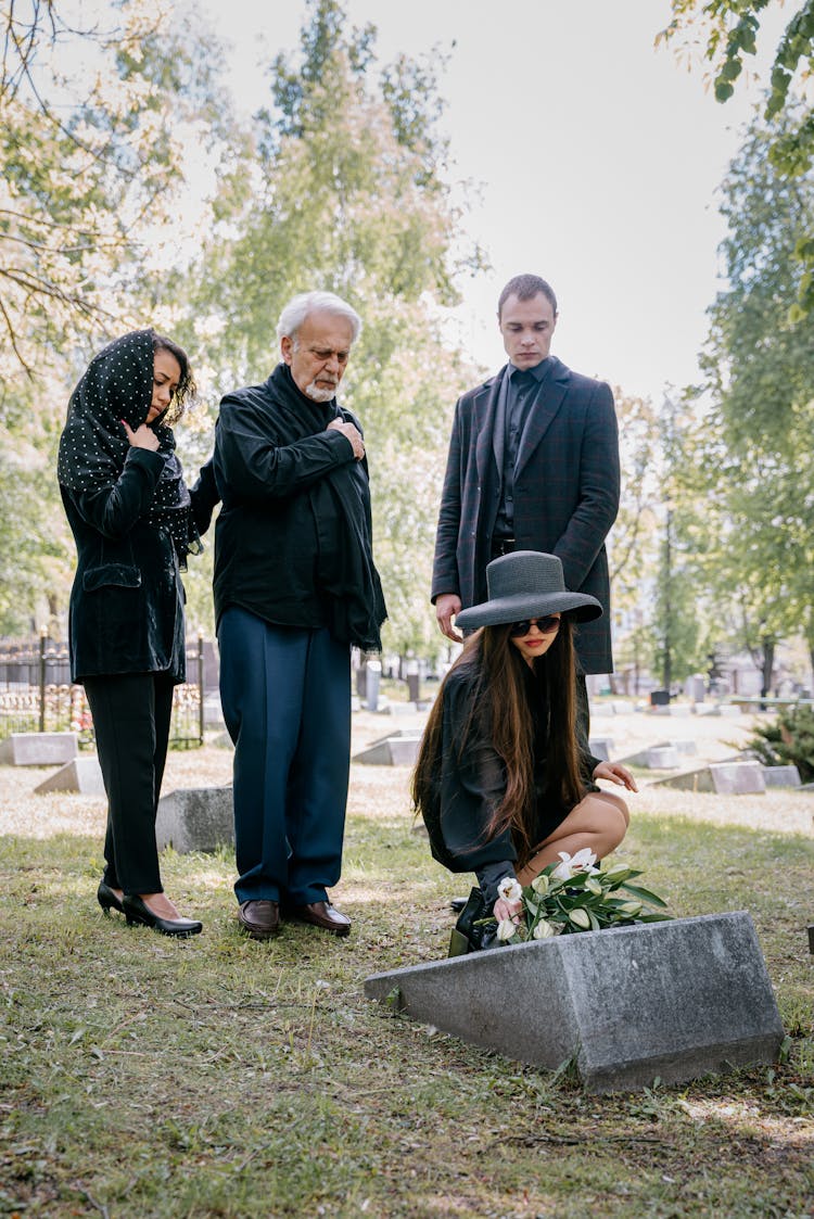 A Family Mourning In A Cemetery