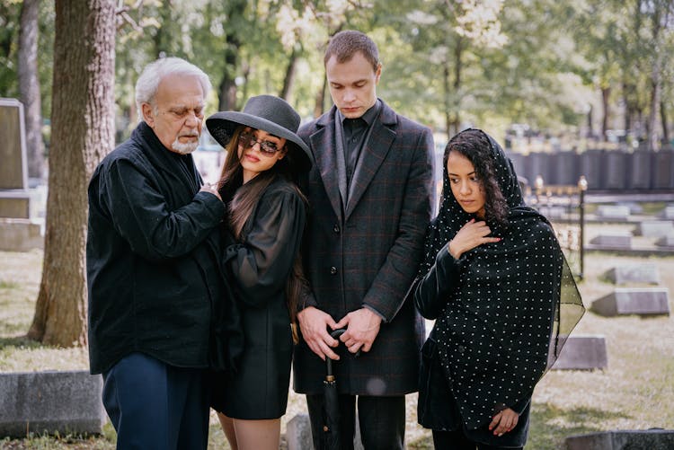 A Grieving Family At A Cemetery