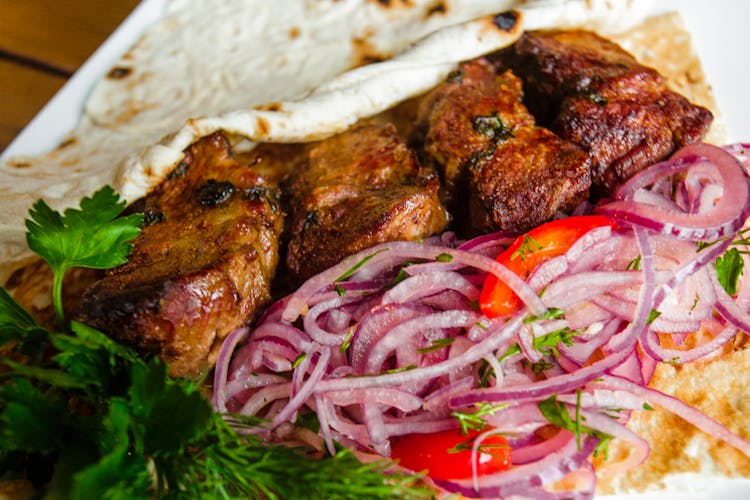 Close Up Photo Of Cooked Meat And Sliced Onions