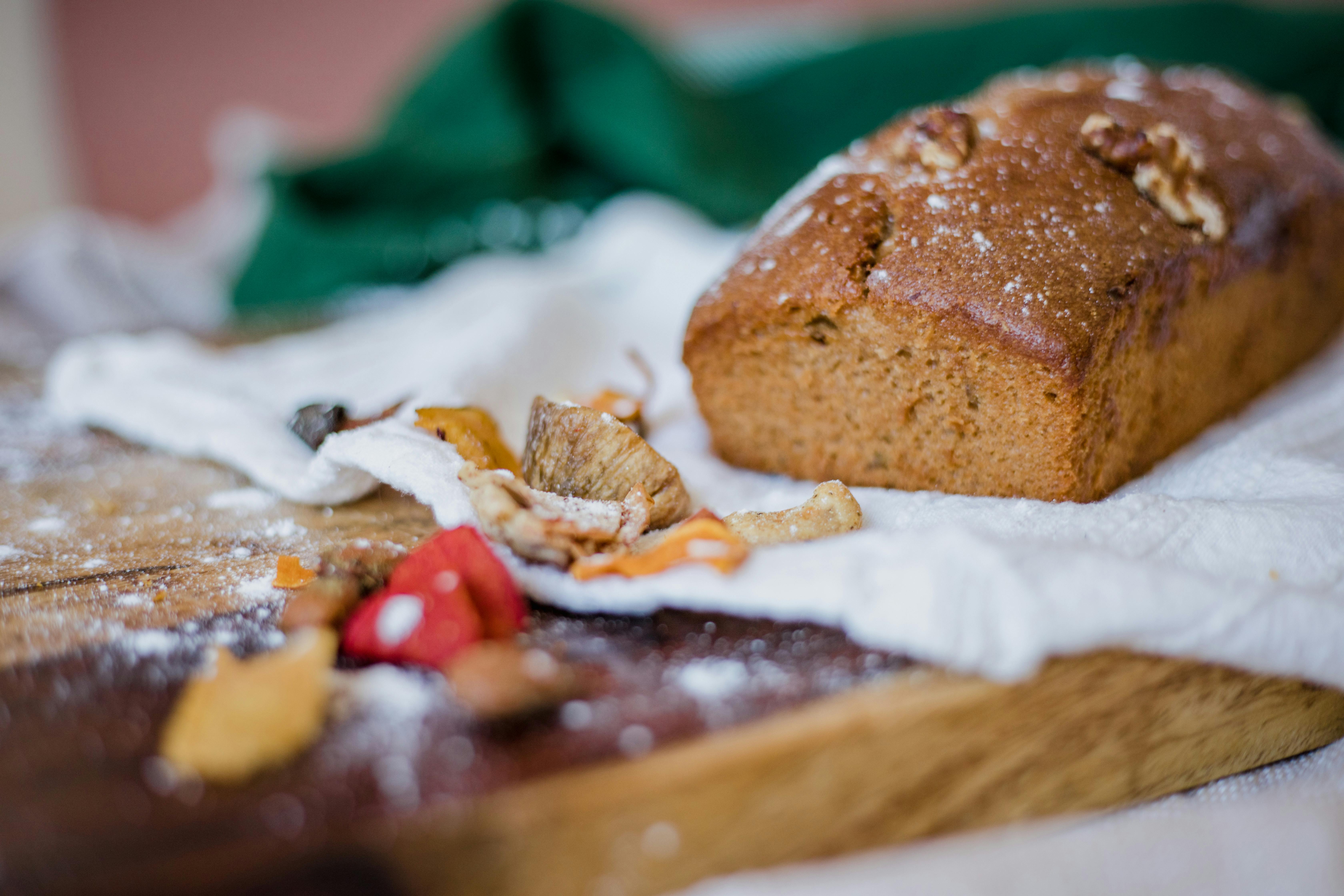 loaf of bread on brown wooden chopping board