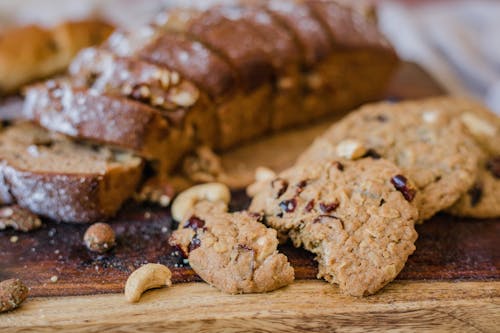 Free Brown Bread and Cookies on a Wooden Board Stock Photo