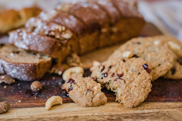 Brown Bread And Cookies On A Wooden Board
