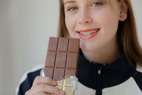 Woman Holding a Chocolate Bar 