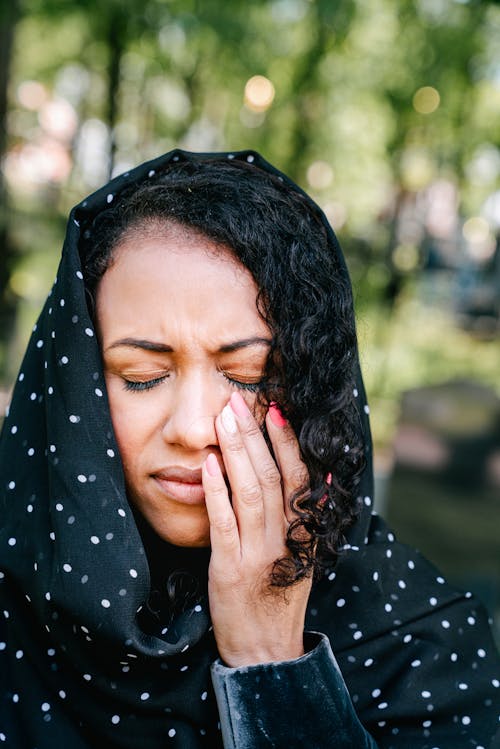 Free Woman in Black and White Polka Dot Hijab Crying Stock Photo