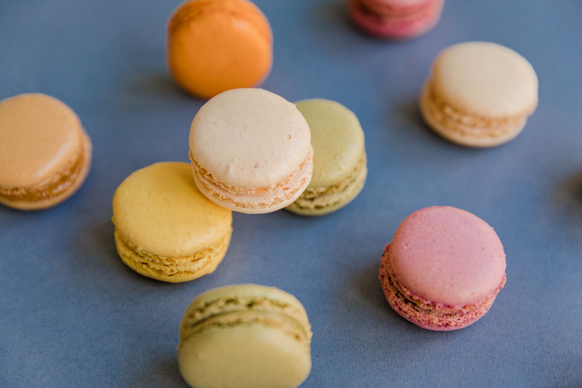 Colorful French macarons stacked in a bakery display
