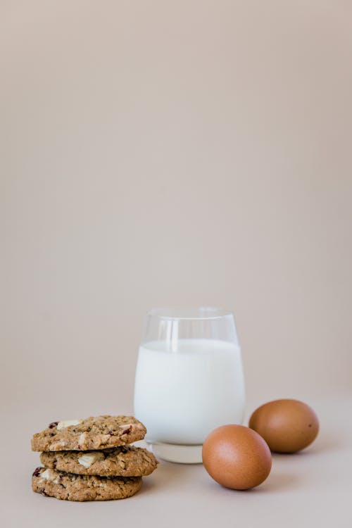 Eggs and Cookies Beside a Glass of Milk