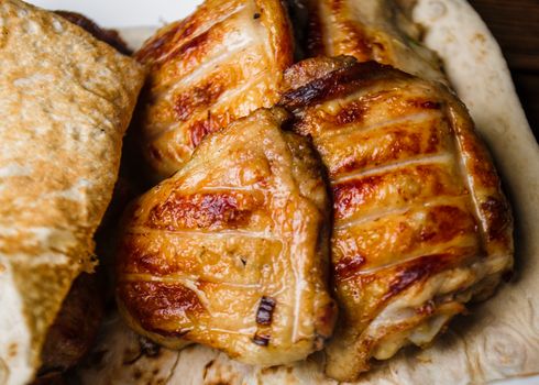 Golden-brown grilled chicken on flatbread for a delicious meal.