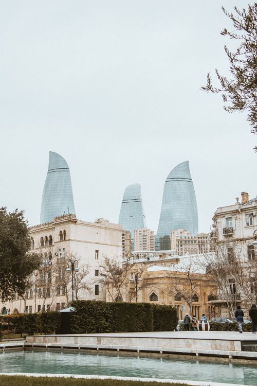 Free View of Baku's skyline featuring the Flame Towers and historical buildings. Stock Photo