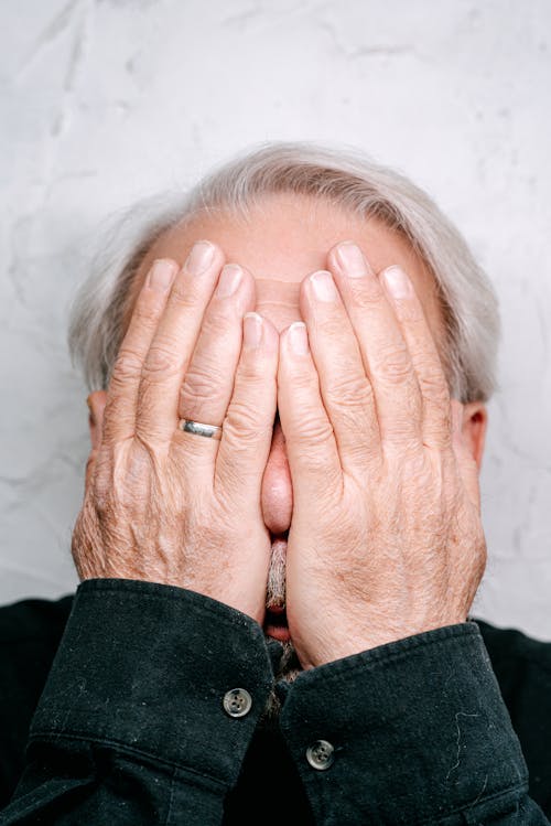 Free Man Covering Face with His Hands Stock Photo