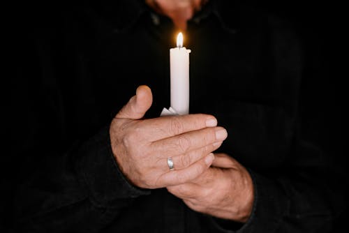 Person Holding a Lighted Candle