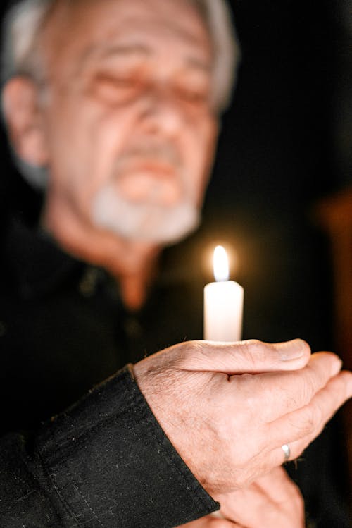 A Man Holding a Lighted Candle