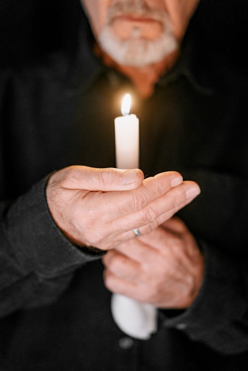 Free Person Holding a White Candle  Stock Photo