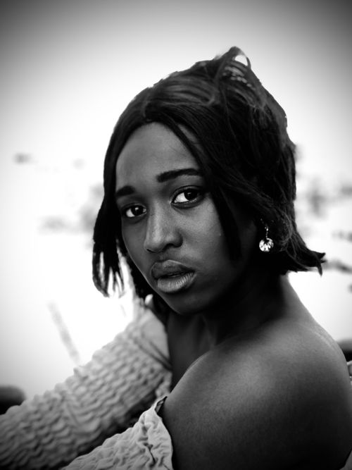 Free Intimate grayscale portrait of a thoughtful young woman looking at the camera. Stock Photo