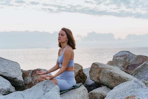 Free A Woman Doing a Meditation near the Ocean during Morning Stock Photo