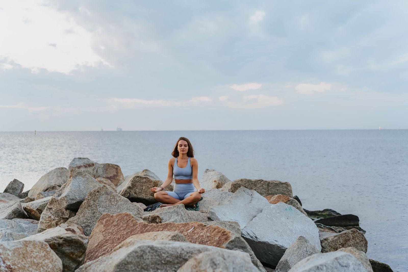 Woman meditating by the sea