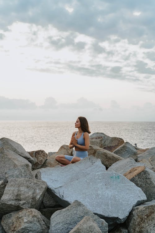 A Woman in Activewear Meditating