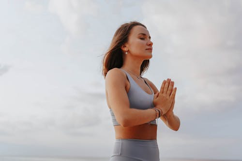 Close-Up Shot of a Woman Doing a Yoga Exercise during Morning