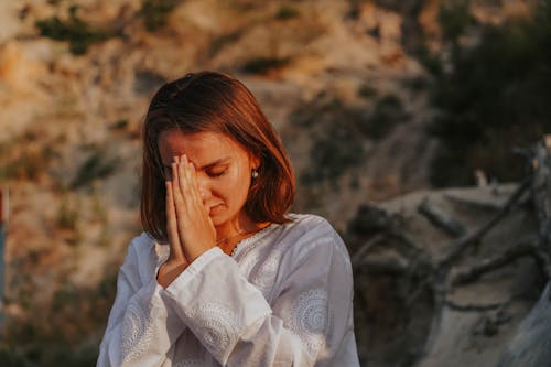 Woman in White Long Sleeve Shirt Meditating