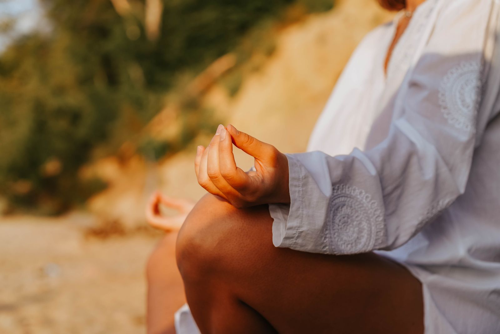 Person practicing seated breathing exercises and pranayama for digestive health