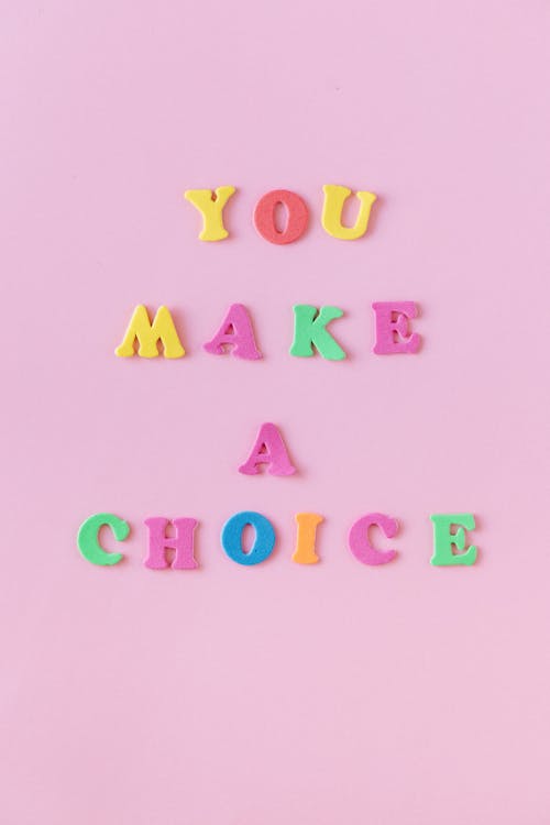 Colorful Letters on a Pink Background Creating a Sentence You Make a Choice
