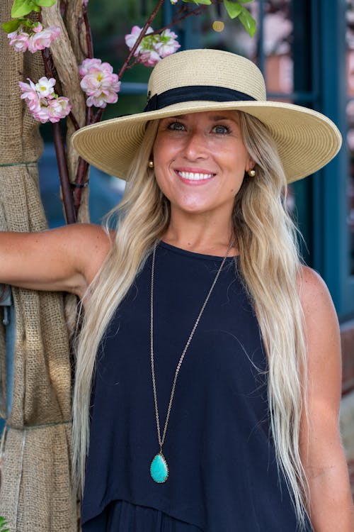 A Woman in Black Tank Top Wearing a Hat