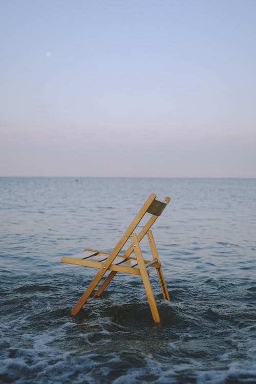Free Wooden Chair in Shallow Water Stock Photo