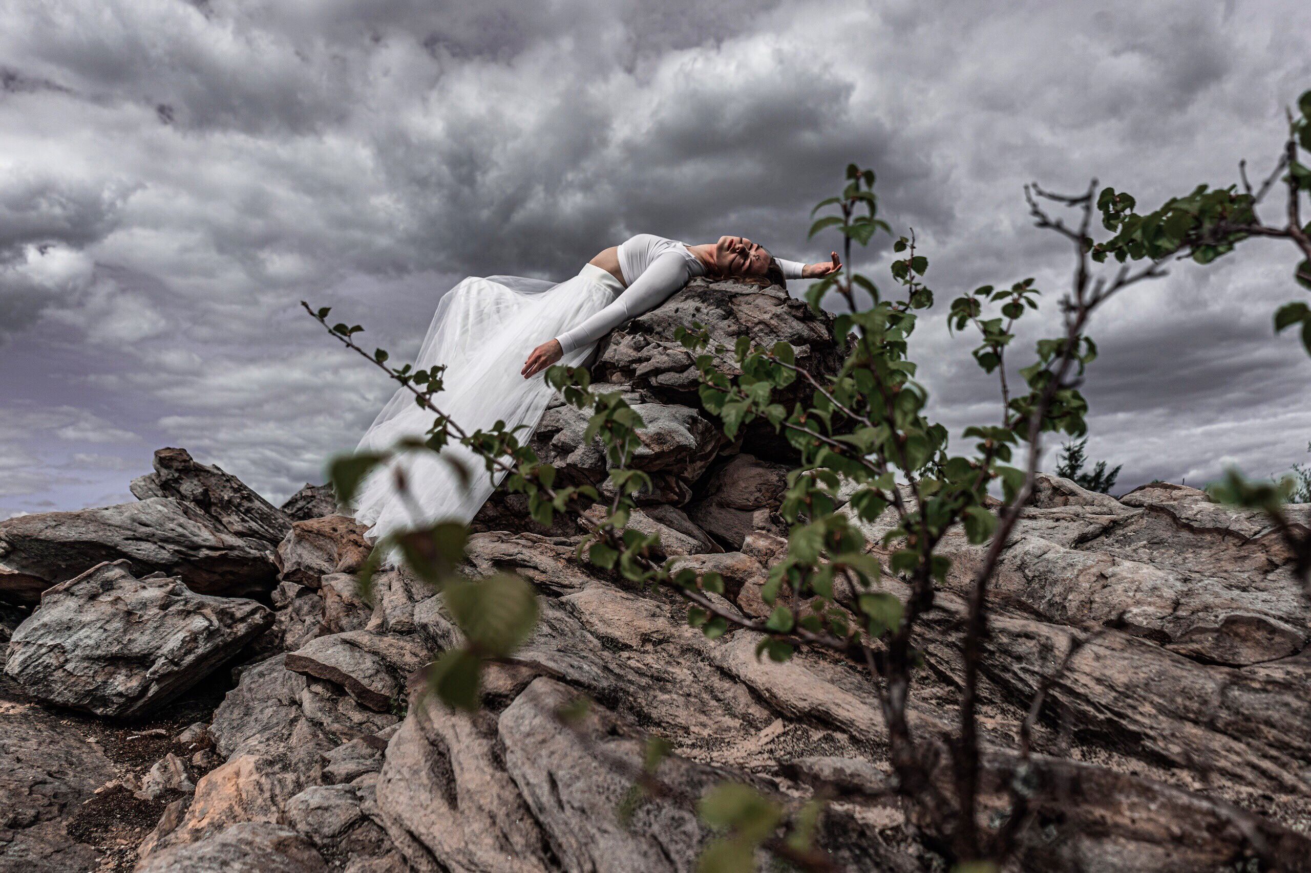 Woman in White Dress Lying on a Big Rock · Free Stock Photo