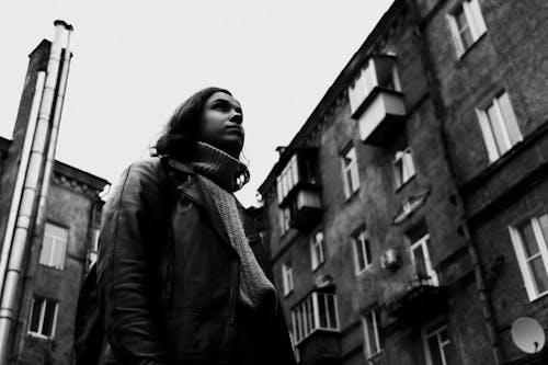 Grayscale Photo of a Woman in Leather Jacket